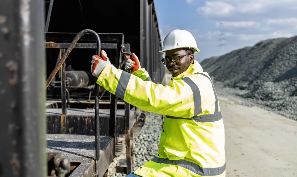 train work climbing onto cargo train